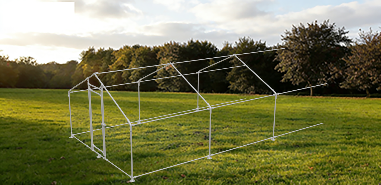 White metal frame structure on a grassy field with trees in the background